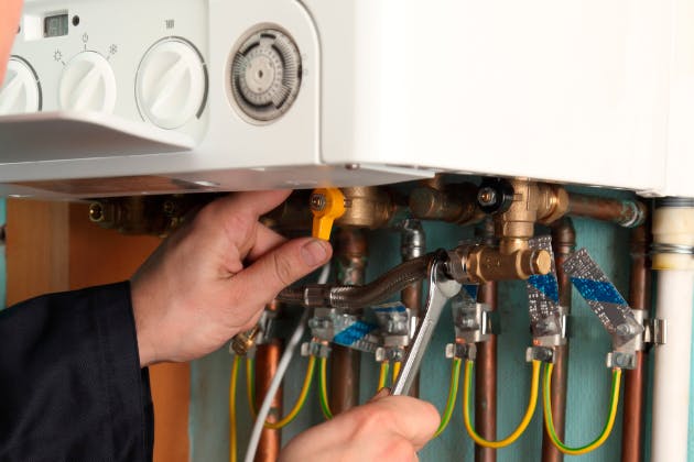 man repairing boiler
